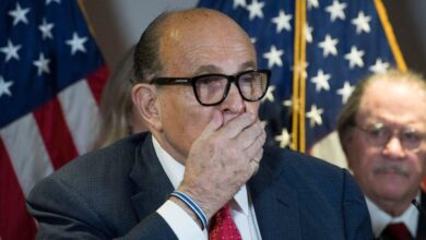 Disgraced ex-Trump lawyer Rudy Giuliani falls from his chair at RNC