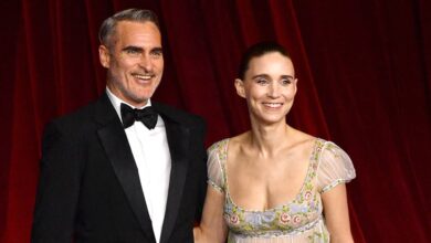 Joaquin Phoenix fixes Rooney Mara's train at Academy Gala