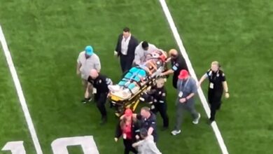 Miami Dolphins receiver Grant DuBose is stretched out off the field in a scary scene