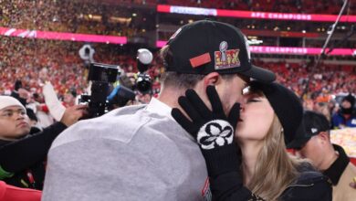 Taylor Swift kisses and hugs Travis Kelce on the field after the Chiefs win