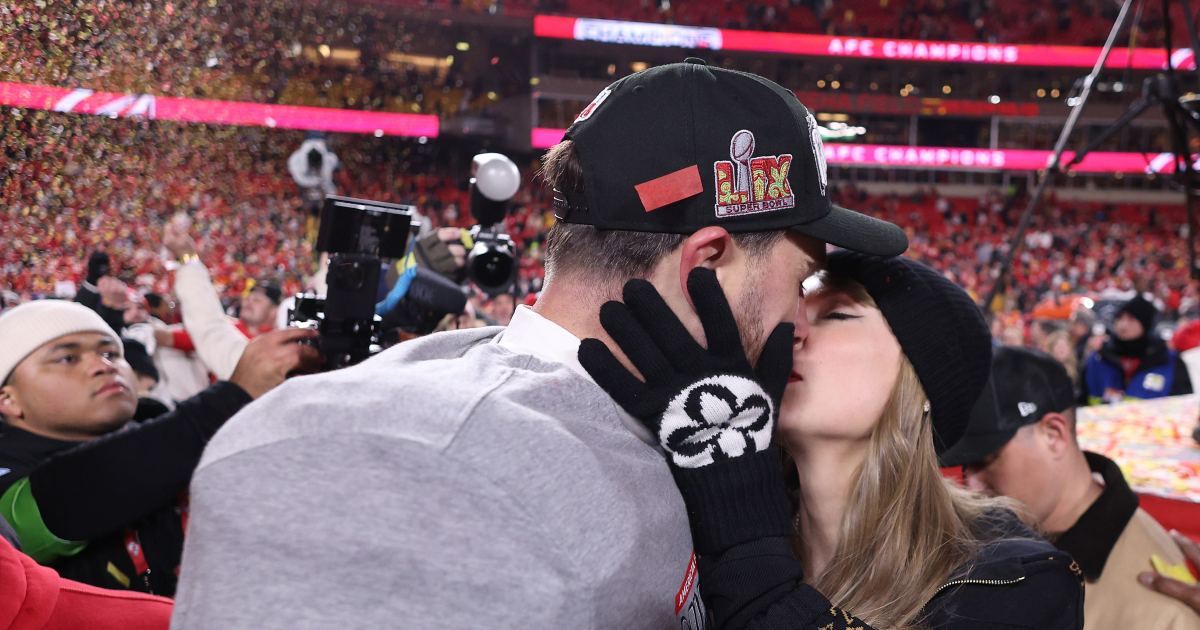 Taylor Swift kisses and hugs Travis Kelce on the field after the Chiefs win