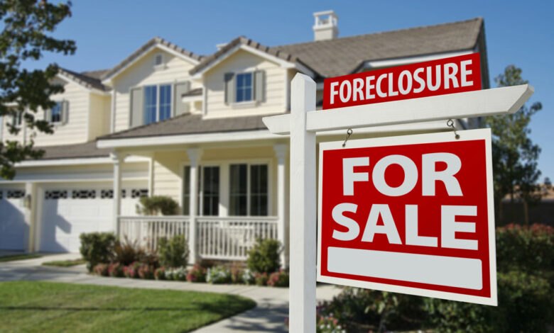 Foreclosure Home For Sale Sign in Front of Beautiful House.