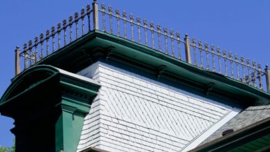 A wrought-iron widow's walk topping a 19th century house