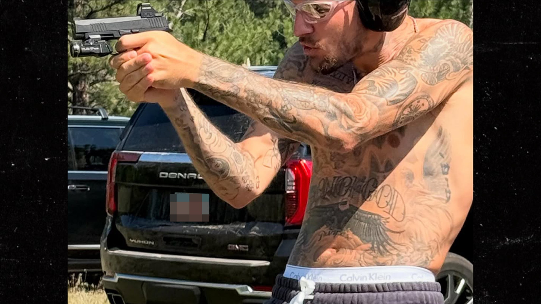 Justin Bieber shoots weapons with shirtless