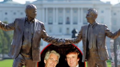 Donald Trump hits the statue that holds him hand in hand with Jeffrey Epstein