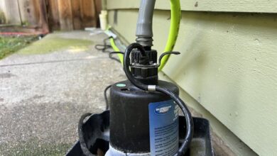 Close-up of a Superior Pump brand pump with green hose attached, located on an outdoor concrete path next to a residential home, Lafayette, California, May 29, 2024.