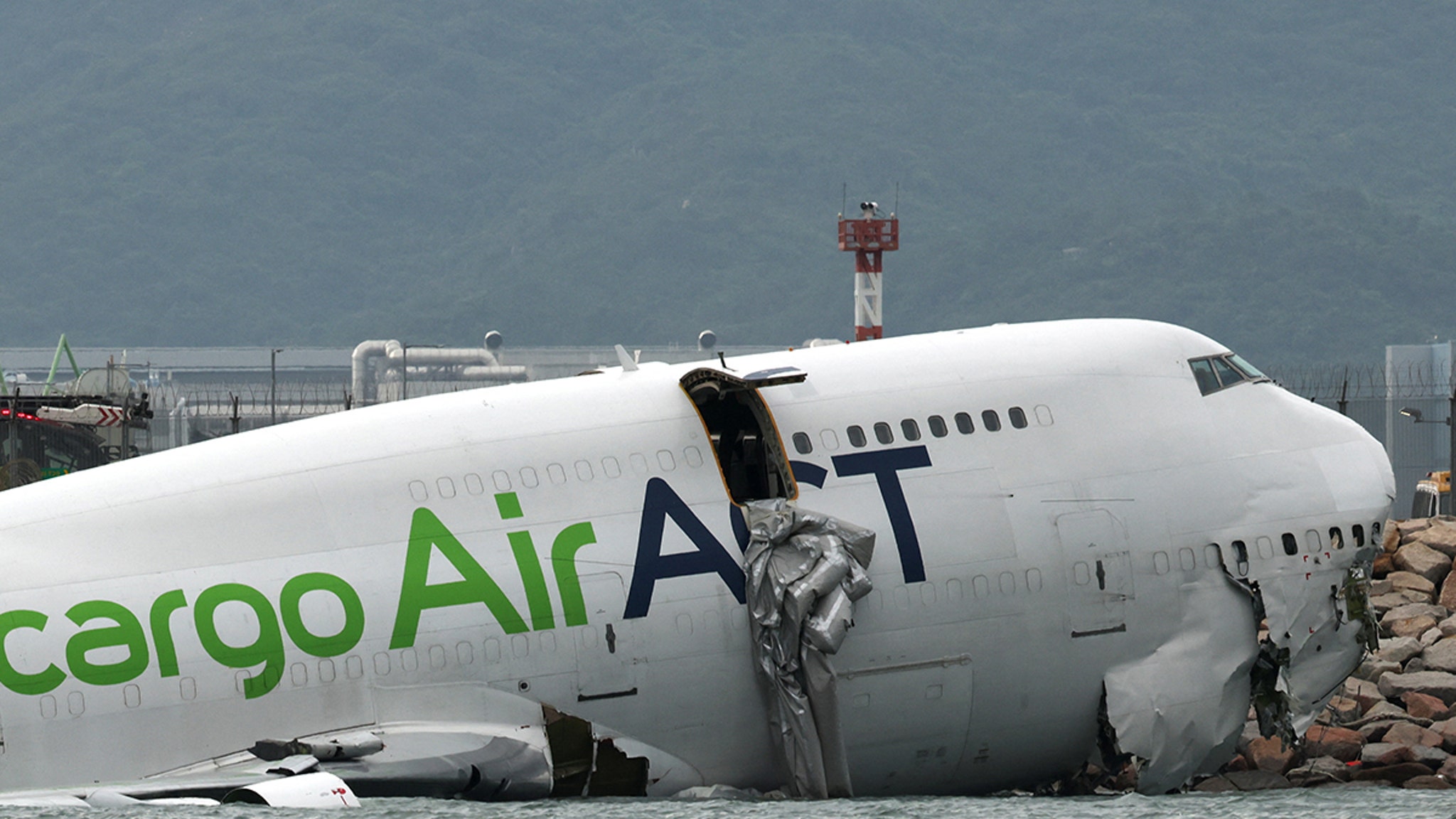 Two dead after cargo plane skids off runway at Hong Kong airport