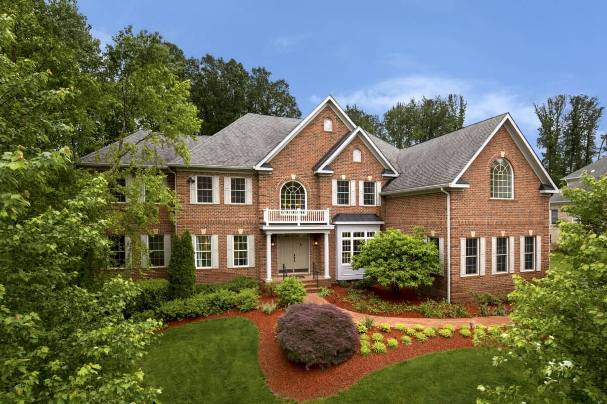 Exterior of a red brick single-family home in Fairfax, VA, commonly used in articles explaining can a seller refuse to pay a buyer’s agent.