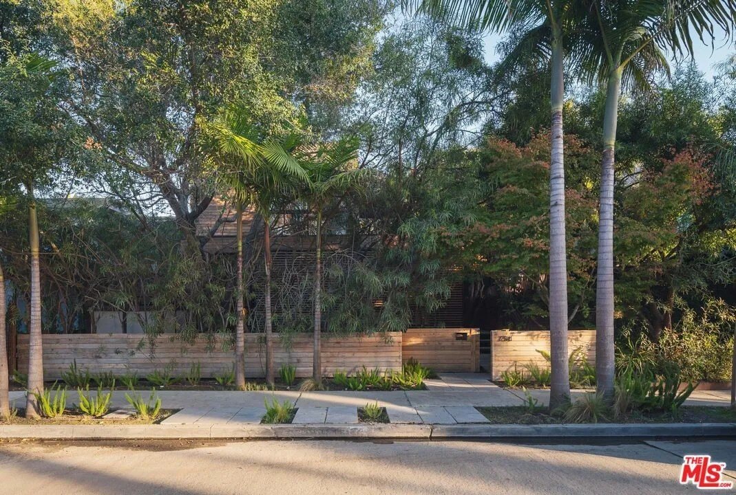 Discreet from the street, this home's mature foliage provides both shade and privacy.