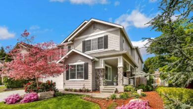 Tan house with flowers in yard