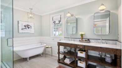 A bright bathroom with a tub and wood vanity