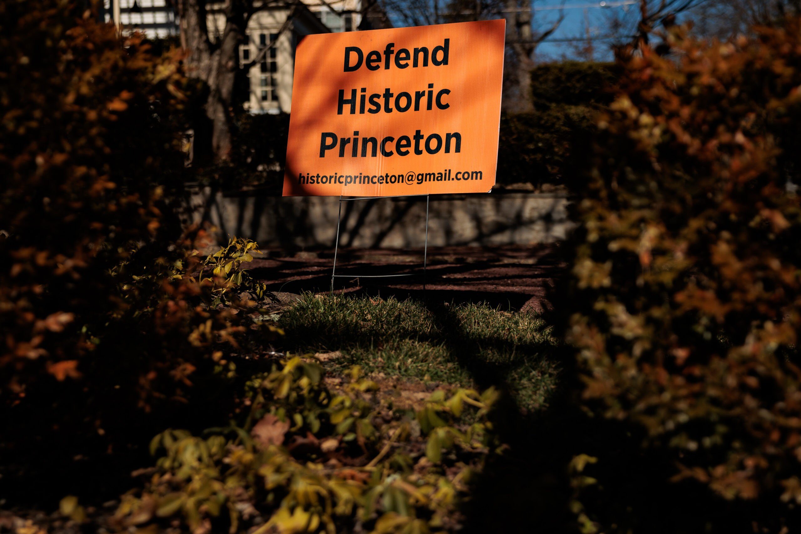 Read signage "Defend historic Princeton" is depicted across the street from Albert Einstein's house