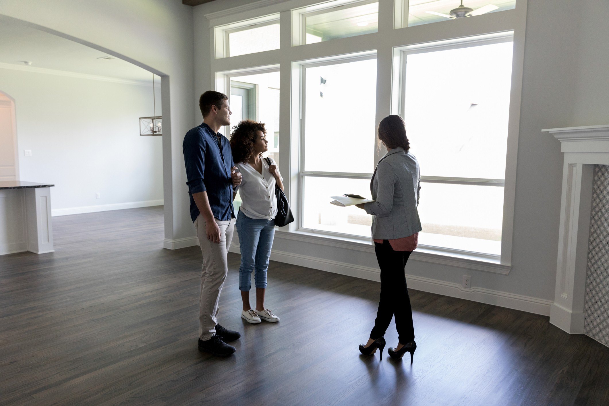 couple with agent looking at a house