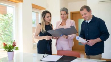 People standing around looking at documents illustrating how to negotiate on house price